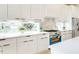 Well-lit kitchen with stainless appliances, white cabinets, and quartz countertops at 322 S Dixon Ave # R, Cary, NC 27511