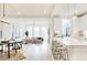 Open-concept kitchen with an island, counter seating, modern pendant lights, and an adjacent living area at 322 S Dixon Ave # R, Cary, NC 27511