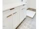 Bright laundry room features modern white cabinets, sleek hardware, and durable tile flooring, perfect for organization at 322 S Dixon Ave # R, Cary, NC 27511
