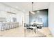 Open concept kitchen, living and dining area with wood floors and modern lighting at 322 S Dixon Ave # R, Cary, NC 27511