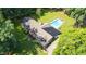 An aerial view of a home with an in-ground pool and a large, tree-filled yard at 3315 Swepsonville Saxapahaw Rd, Graham, NC 27253