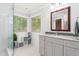 Stylish bathroom with a glass shower, modern vanity, and a large decorative mirror at 3315 Swepsonville Saxapahaw Rd, Graham, NC 27253