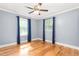 Bright bedroom with hardwood floors, dual windows, and a ceiling fan at 3315 Swepsonville Saxapahaw Rd, Graham, NC 27253