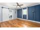 Comfortable bedroom with hardwood floors, an open closet, and a ceiling fan at 3315 Swepsonville Saxapahaw Rd, Graham, NC 27253