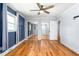 The spacious bedroom features a ceiling fan, hardwood floors, and mirrored closets at 3315 Swepsonville Saxapahaw Rd, Graham, NC 27253