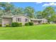 Charming single-story home with a well-maintained lawn, mature trees, and a classic brick exterior with black shutters at 3315 Swepsonville Saxapahaw Rd, Graham, NC 27253