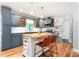 Stylish kitchen featuring blue cabinets, a butcher block island, stainless steel appliances, and subway tile backsplash at 3315 Swepsonville Saxapahaw Rd, Graham, NC 27253