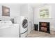 Functional laundry room with modern washer and dryer, ample storage, and a bright, clean aesthetic at 3315 Swepsonville Saxapahaw Rd, Graham, NC 27253