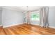 Bright living room with hardwood floors, modern lighting, and large window with serene view at 3315 Swepsonville Saxapahaw Rd, Graham, NC 27253