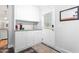 Functional mud room with white cabinetry, granite countertop, utility sink, and convenient access to the outdoors at 3315 Swepsonville Saxapahaw Rd, Graham, NC 27253