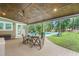 Cozy covered patio featuring a ceiling fan, chairs and a view of the refreshing pool and backyard at 3315 Swepsonville Saxapahaw Rd, Graham, NC 27253