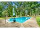 Inviting backyard pool surrounded by lush greenery, perfect for relaxation and recreation at 3315 Swepsonville Saxapahaw Rd, Graham, NC 27253