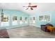 Inviting sunroom with many windows, light walls, ceiling fan, and access to the pool at 3315 Swepsonville Saxapahaw Rd, Graham, NC 27253