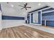 Stylish attic featuring a reading nook with custom-built bookshelves, modern lighting, and wood-look flooring at 503 Bendemeer Ln, Rolesville, NC 27571