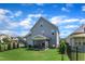 Green backyard with black fence, shrubs and screen porch at 503 Bendemeer Ln, Rolesville, NC 27571