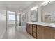 Bright bathroom with double vanity, mirrors, shower, and soaking tub at 503 Bendemeer Ln, Rolesville, NC 27571