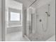 Bright bathroom featuring tiled floors, glass shower, and separate soaking tub at 503 Bendemeer Ln, Rolesville, NC 27571