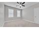 A cozy bedroom with neutral carpet, two windows, and a ceiling fan at 503 Bendemeer Ln, Rolesville, NC 27571