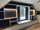 Cozy bonus room featuring custom built-in shelves, cabinets, and a window seat nook at 503 Bendemeer Ln, Rolesville, NC 27571