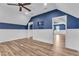 Spacious bonus room featuring white wainscoting, wood flooring, and a ceiling fan at 503 Bendemeer Ln, Rolesville, NC 27571