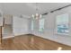 Bright dining room with hardwood floors, wainscoting, and a modern chandelier fixture at 503 Bendemeer Ln, Rolesville, NC 27571