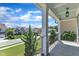 Inviting front porch featuring white columns, iron railings, and serene neighborhood views at 503 Bendemeer Ln, Rolesville, NC 27571