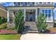 Inviting front porch with stone accents, decorative plants, and secure ADT system at 503 Bendemeer Ln, Rolesville, NC 27571