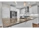Bright kitchen featuring granite countertops, stainless appliances, and modern pendant lighting at 503 Bendemeer Ln, Rolesville, NC 27571