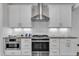 Modern kitchen features stainless steel appliances, white cabinets and granite countertops at 503 Bendemeer Ln, Rolesville, NC 27571