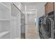 A functional laundry room with built-in shelving and modern washer and dryer units at 503 Bendemeer Ln, Rolesville, NC 27571
