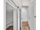 Bright pantry with a sliding door and white shelving for optimal kitchen storage at 503 Bendemeer Ln, Rolesville, NC 27571