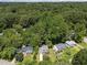 An aerial view of the neighborhood, surrounded by lush, mature trees at 505 Drolmond Dr, Raleigh, NC 27615
