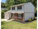 Two-story home featuring a brick facade, blue door, landscaped yard, and an attached one car garage at 505 Drolmond Dr, Raleigh, NC 27615