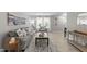 Well lit living room with hardwood floors, neutral paint, modern furniture, and an open doorway at 505 Drolmond Dr, Raleigh, NC 27615