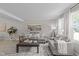 Bright living room featuring hardwood floors, neutral paint, modern furnishings, and natural light at 505 Drolmond Dr, Raleigh, NC 27615