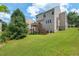 Home backyard featuring a deck with stairs leading down to a spacious lawn, ideal for outdoor activities at 507 Turmeric Ln, Durham, NC 27713