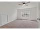 Spacious bedroom with neutral carpet, bright window and a modern ceiling fan for comfort and style at 507 Turmeric Ln, Durham, NC 27713