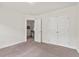 This is a nice bedroom with beige colored walls and a closet with white doors at 507 Turmeric Ln, Durham, NC 27713