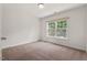 Clean bedroom with lots of natural light, neutral colors and carpeted flooring at 507 Turmeric Ln, Durham, NC 27713