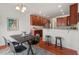 Charming dining area with hardwood floors, breakfast bar, and a partial view of the kitchen at 507 Turmeric Ln, Durham, NC 27713