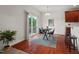 Bright dining area with hardwood floors, sliding glass doors to a deck, and a modern table setting at 507 Turmeric Ln, Durham, NC 27713