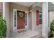 Inviting front porch with a wooden door adorned by a wreath and a colorful doormat at 507 Turmeric Ln, Durham, NC 27713