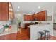 Well-lit kitchen featuring granite countertops, stainless steel appliances, and a view into the dining area at 507 Turmeric Ln, Durham, NC 27713