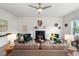 Cozy living room with a fireplace, neutral carpet, comfortable seating, and stylish decor at 507 Turmeric Ln, Durham, NC 27713