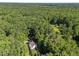 An aerial shot showcasing the property surrounded by lush forest, highlighting the property's secluded location at 5216 Woods End Rd, Hillsborough, NC 27278