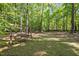 Backyard featuring a wooden swing set and picnic table, creating an inviting outdoor space at 5216 Woods End Rd, Hillsborough, NC 27278