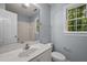 Bathroom with a large mirror, bright window, and a toilet at 5216 Woods End Rd, Hillsborough, NC 27278