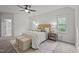 Serene bedroom featuring a woven headboard, soft rug, and plenty of natural light from the double windows at 5216 Woods End Rd, Hillsborough, NC 27278