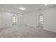Bonus room with neutral walls, carpet, and natural light, providing a versatile space at 5216 Woods End Rd, Hillsborough, NC 27278