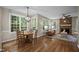 Dining area showcasing hardwood floors, natural light, and view to living room at 5216 Woods End Rd, Hillsborough, NC 27278